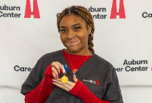 student holding medal
