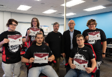 students with instructor and superintendent holding certificates