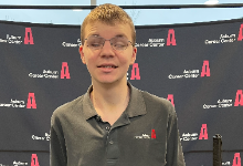 student smiling with Auburn backdrop in background