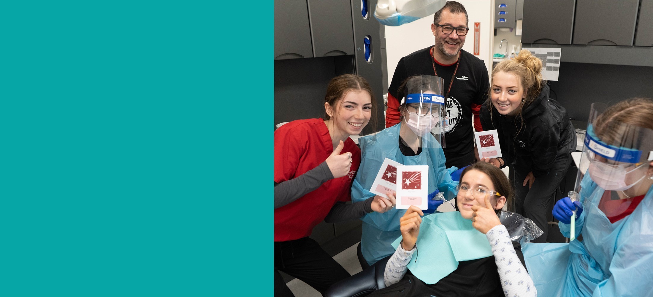 Dental Students smiling and posing with thumbs up and certificates