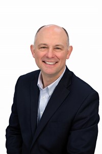 headshot of a man smiling